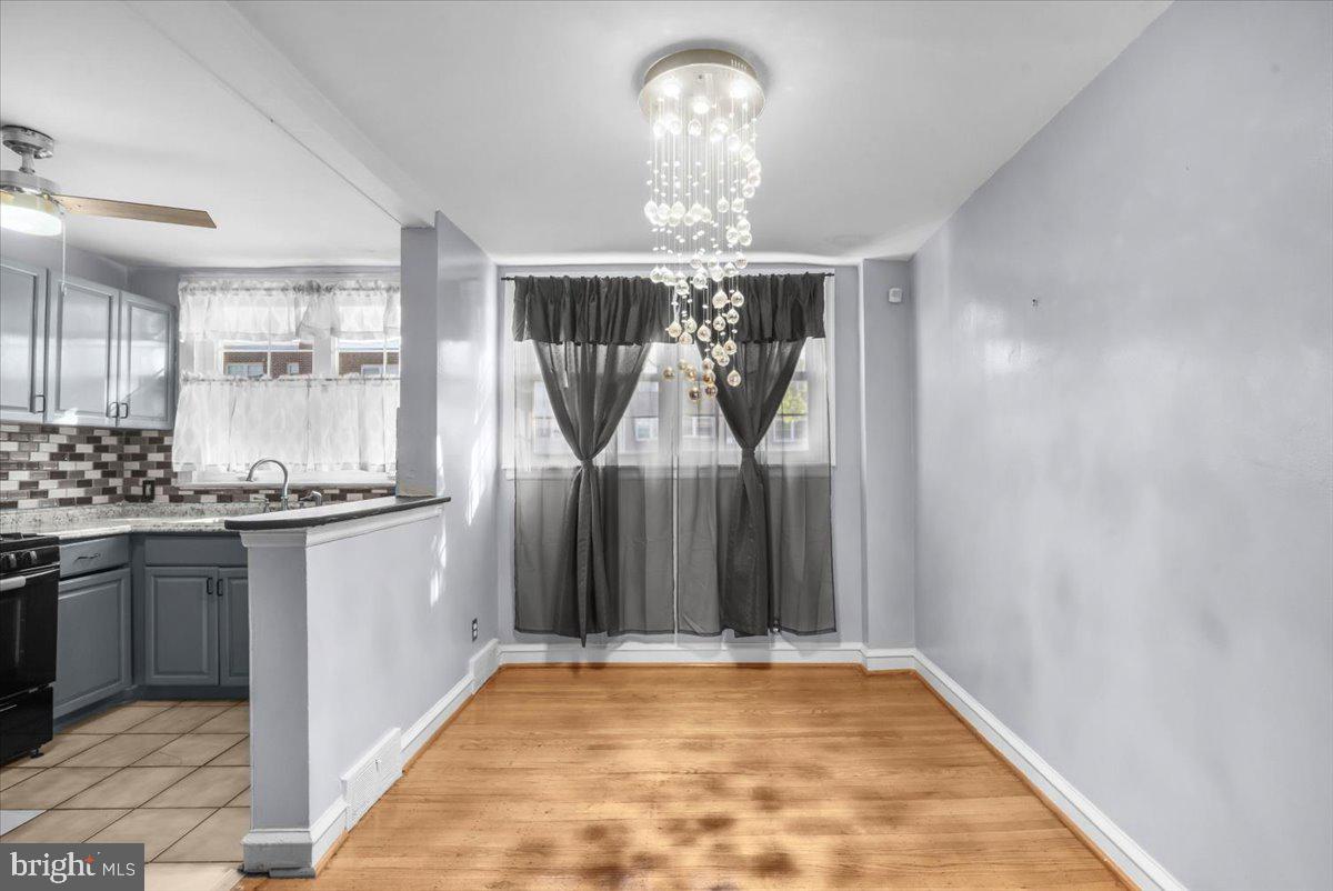 7823 Forrest Avenue Philadelphia, PA 19150 - Photo 8 of 27 a view of a kitchen with granite countertop stainless steel appliances a sink and a window