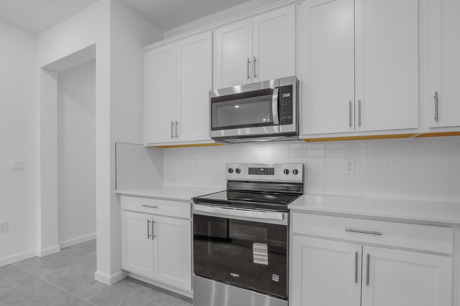 287 Southwest Sally Way Stuart, FL 34997 - Photo 12 of 41 a kitchen with stainless steel appliances granite countertop white cabinets and a stove top oven