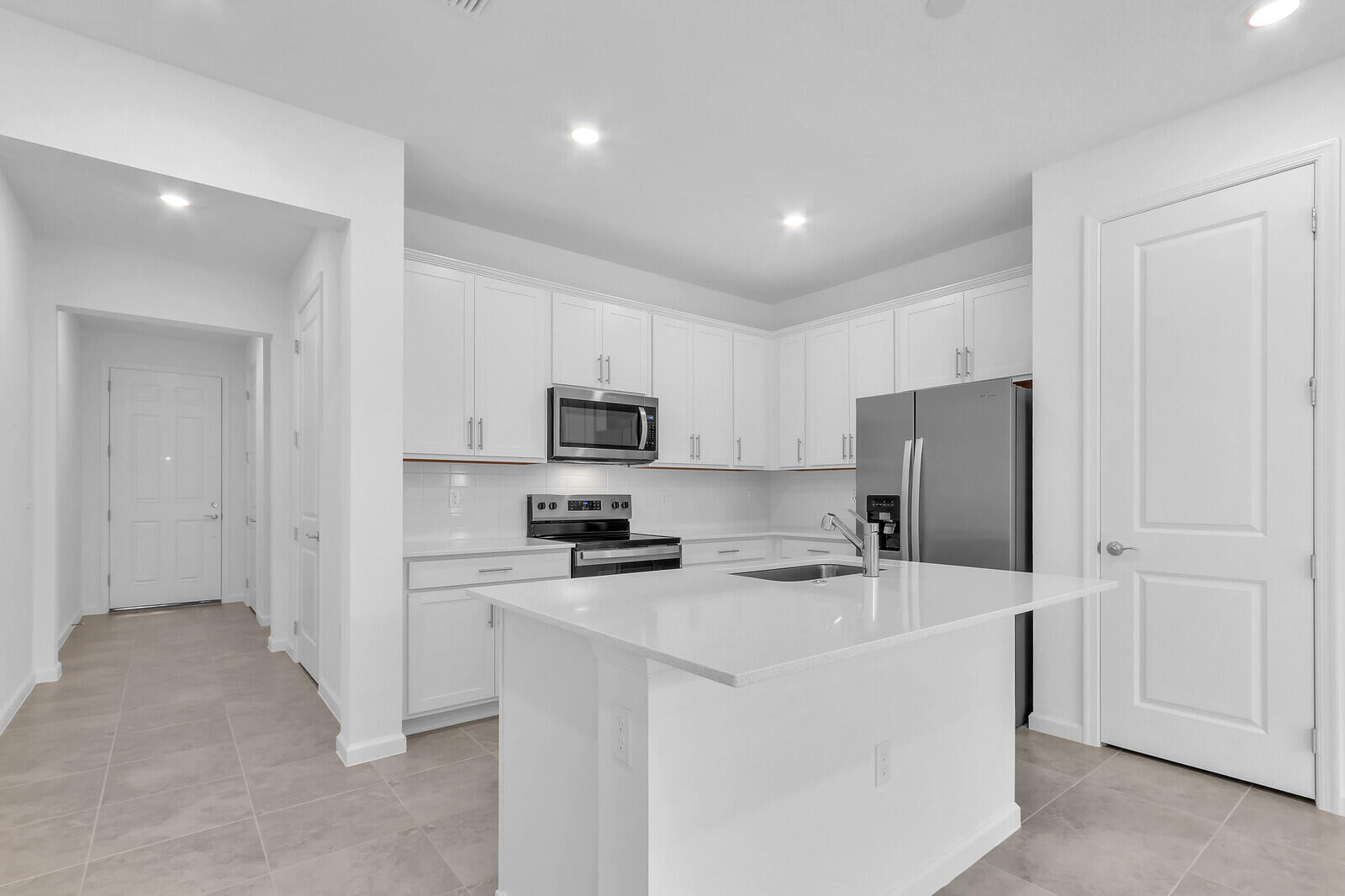 287 Southwest Sally Way Stuart, FL 34997 - Photo 14 of 41 a kitchen with stainless steel appliances a refrigerator stove microwave and sink