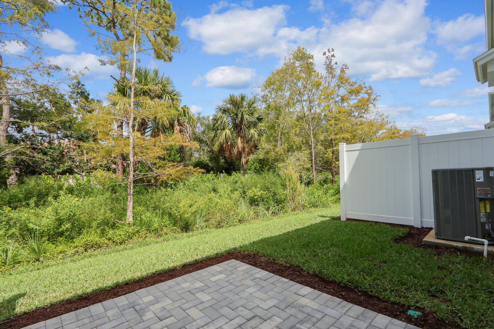 287 Southwest Sally Way Stuart, FL 34997 - Photo 28 of 41 a view of a backyard with potted plants and large tree