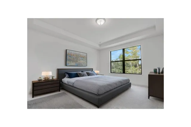 a living room with a bed and a window