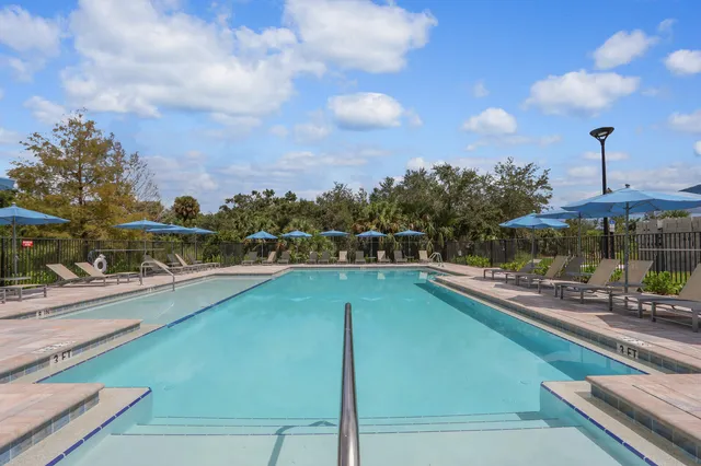 a view of a swimming pool with a chairs