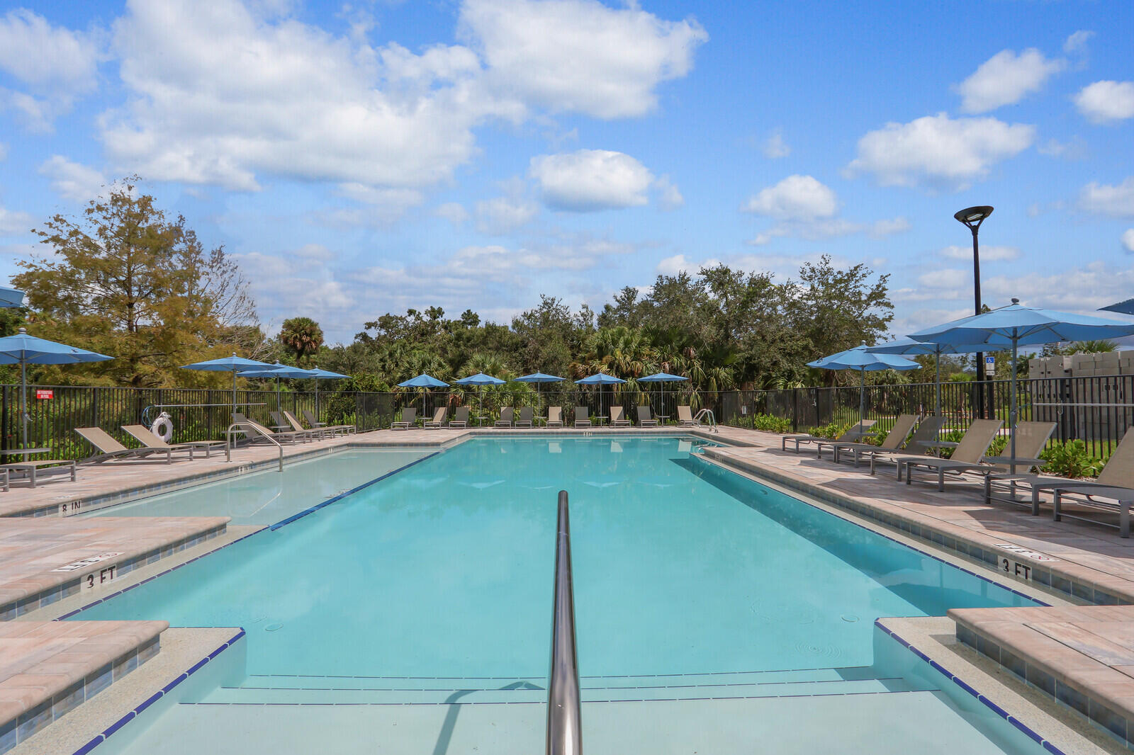 287 Southwest Sally Way Stuart, FL 34997 - Photo 32 of 41 a view of a swimming pool with a chairs