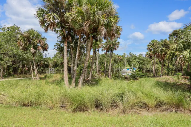 a view of a lake with a table and chairs
