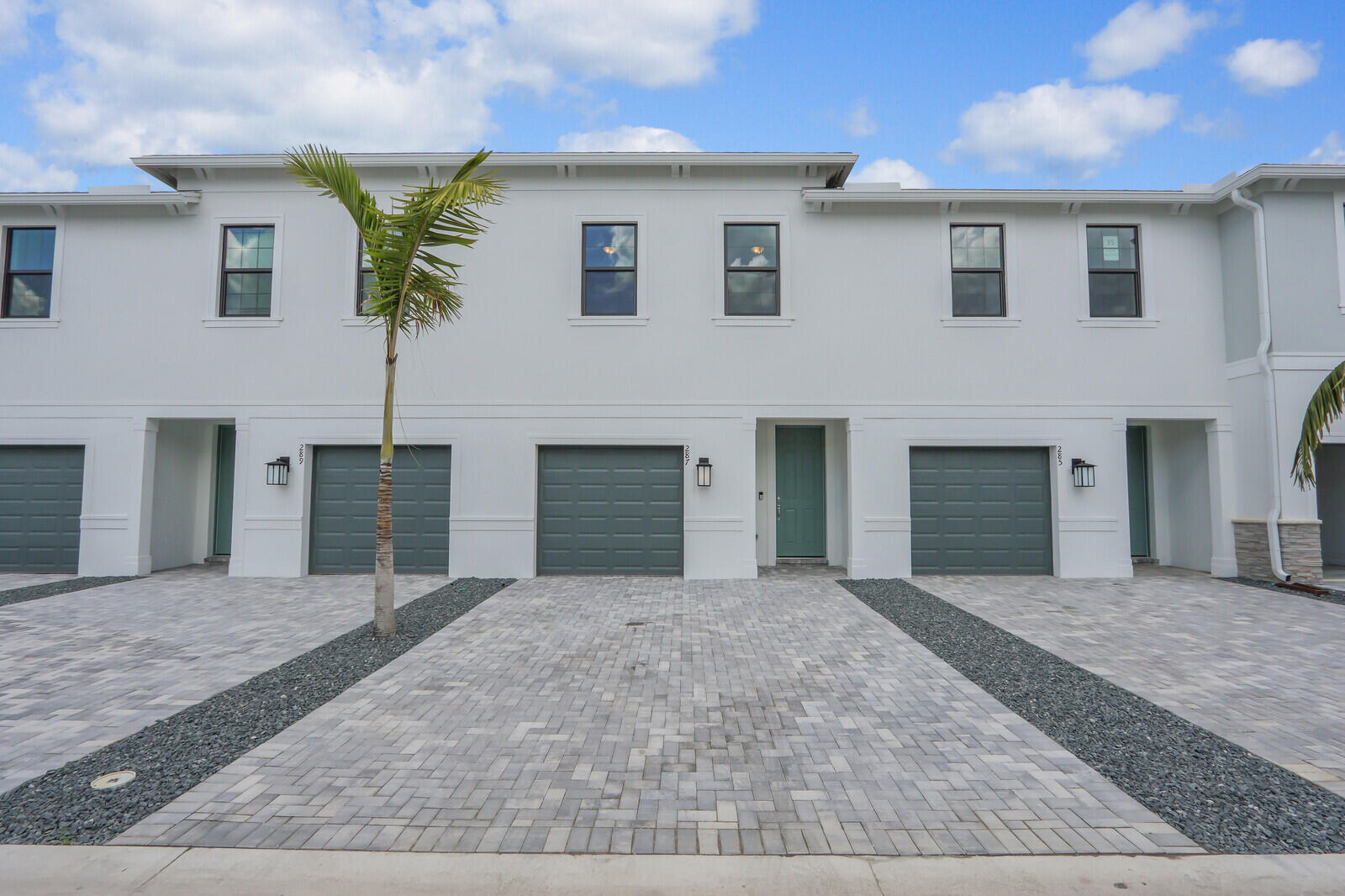 287 Southwest Sally Way Stuart, FL 34997 - Photo 6 of 41 a front view of a house with a yard and garage