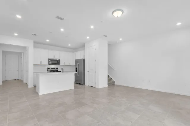 a view of kitchen with stainless steel appliances refrigerator oven