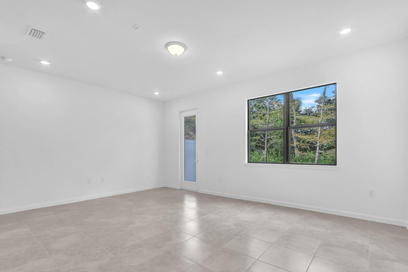 287 Southwest Sally Way Stuart, FL 34997 - Photo 8 of 41 a view of an empty room with a window