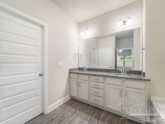 7787 Burnside Loop Pensacola, FL 32526 - Photo 12 of 32 a bathroom with a granite countertop sink and a mirror