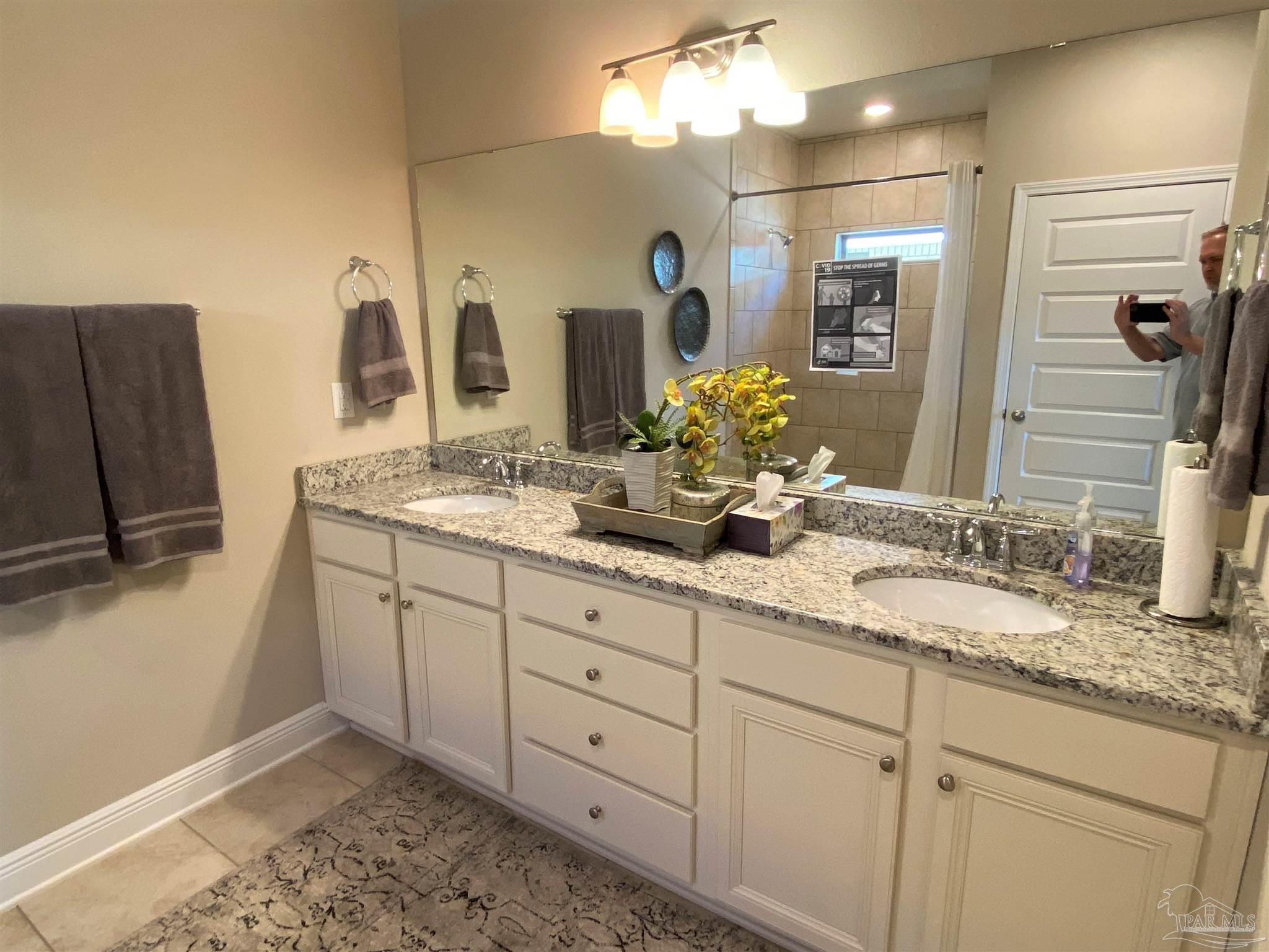 7787 Burnside Loop Pensacola, FL 32526 - Photo 13 of 32 a bathroom with a double vanity sink and mirror