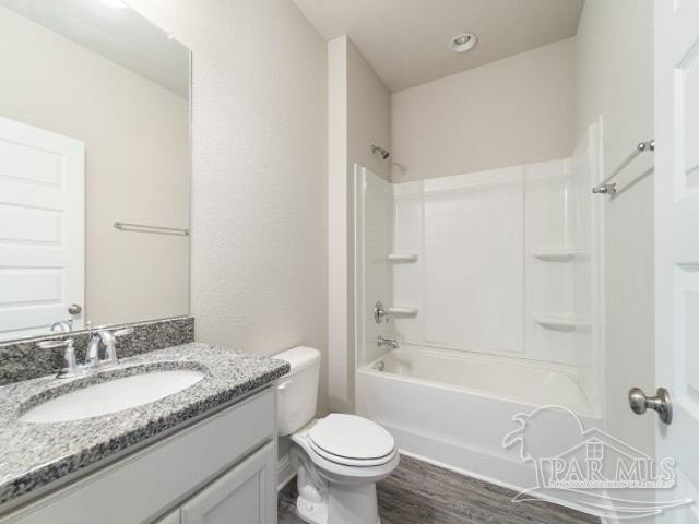 7787 Burnside Loop Pensacola, FL 32526 - Photo 16 of 32 a bathroom with a granite countertop sink toilet and shower