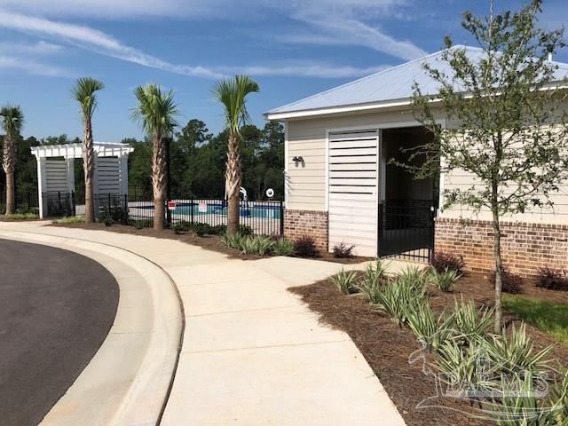 7787 Burnside Loop Pensacola, FL 32526 - Photo 18 of 32 a swimming pool with outdoor seating and yard