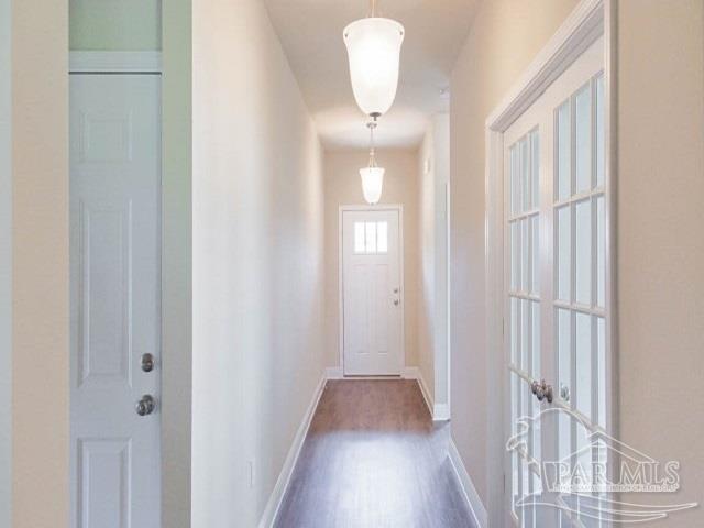 7787 Burnside Loop Pensacola, FL 32526 - Photo 5 of 32 a view of a hallway with wooden floor and staircase