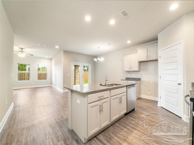 7787 Burnside Loop Pensacola, FL 32526 - Photo 6 of 32 a kitchen with a sink stove and cabinets