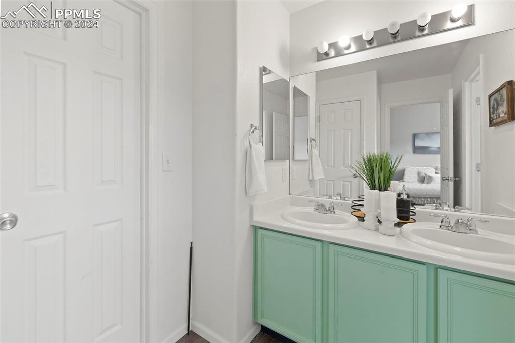 7861 Sandy Springs Point Fountain, CO 80817 - Photo 12 of 18 Bathroom featuring double vanity and walk in closet