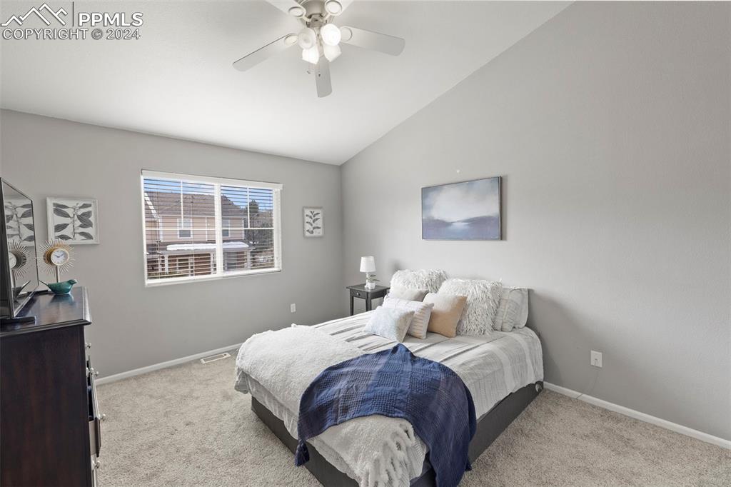 7861 Sandy Springs Point Fountain, CO 80817 - Photo 9 of 18 Carpeted bedroom featuring ceiling fan and vaulted ceiling