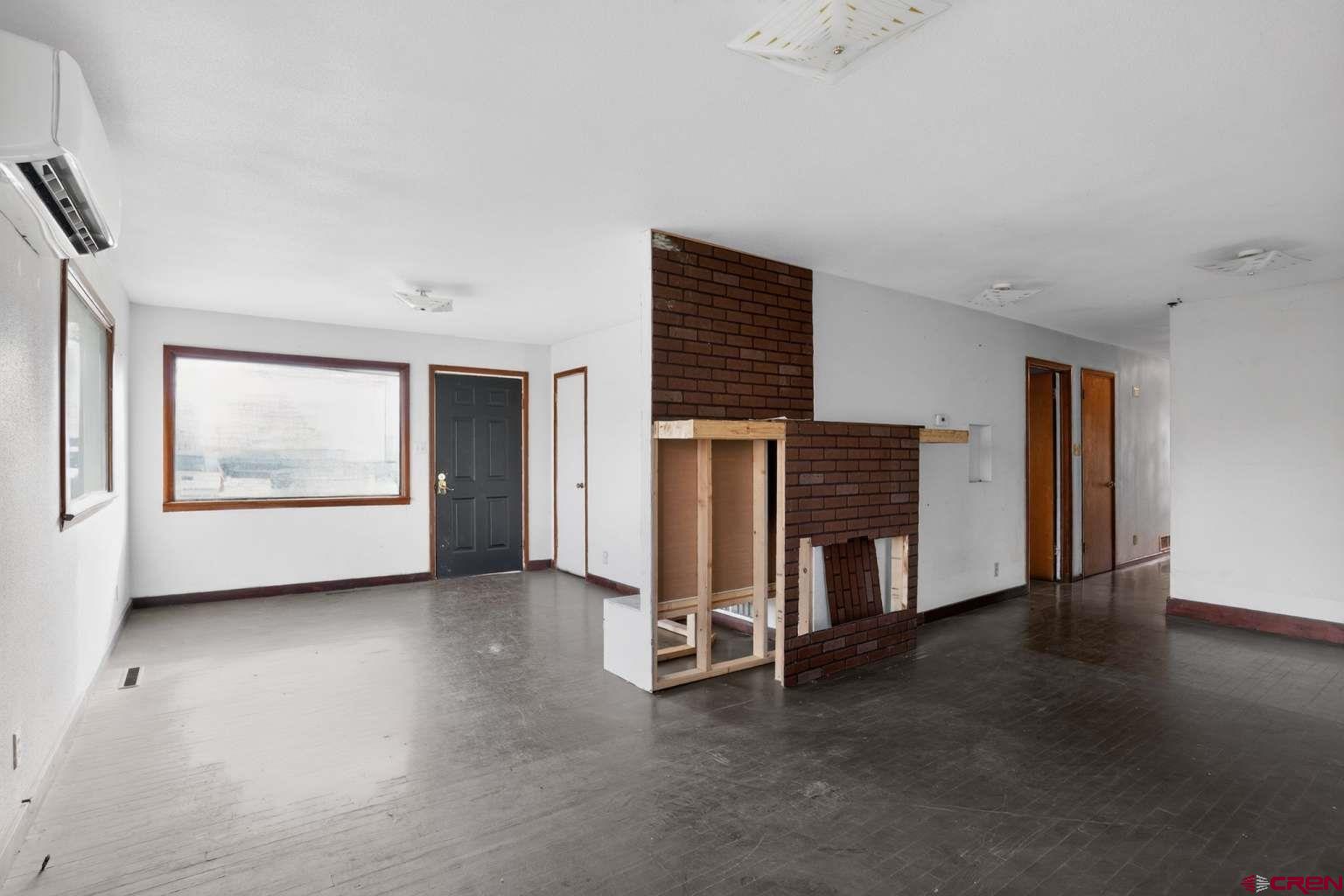 501 East 2nd Street Cortez, CO 81321 - Photo 14 of 30 a view of an empty room with a fireplace