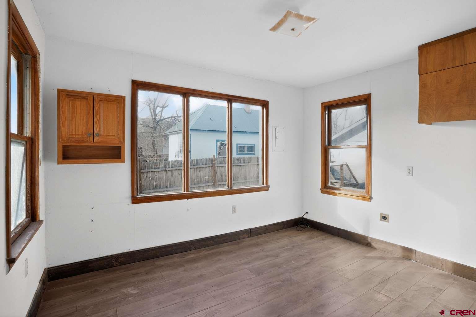 501 East 2nd Street Cortez, CO 81321 - Photo 20 of 30 an empty room with wooden floor and windows