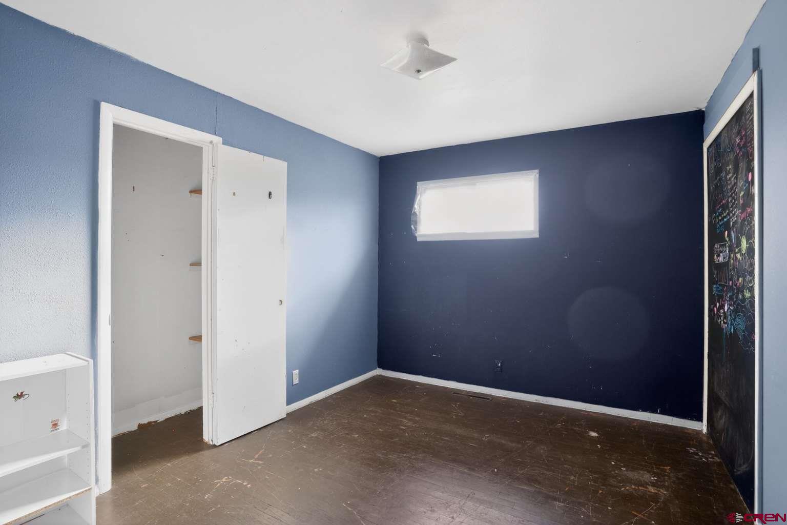 501 East 2nd Street Cortez, CO 81321 - Photo 21 of 30 an empty room with closet and windows