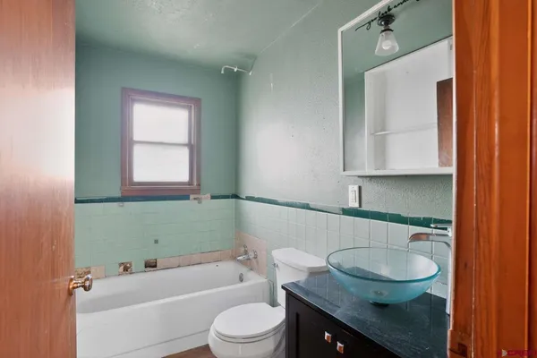 a bathroom with a toilet and a bathtub