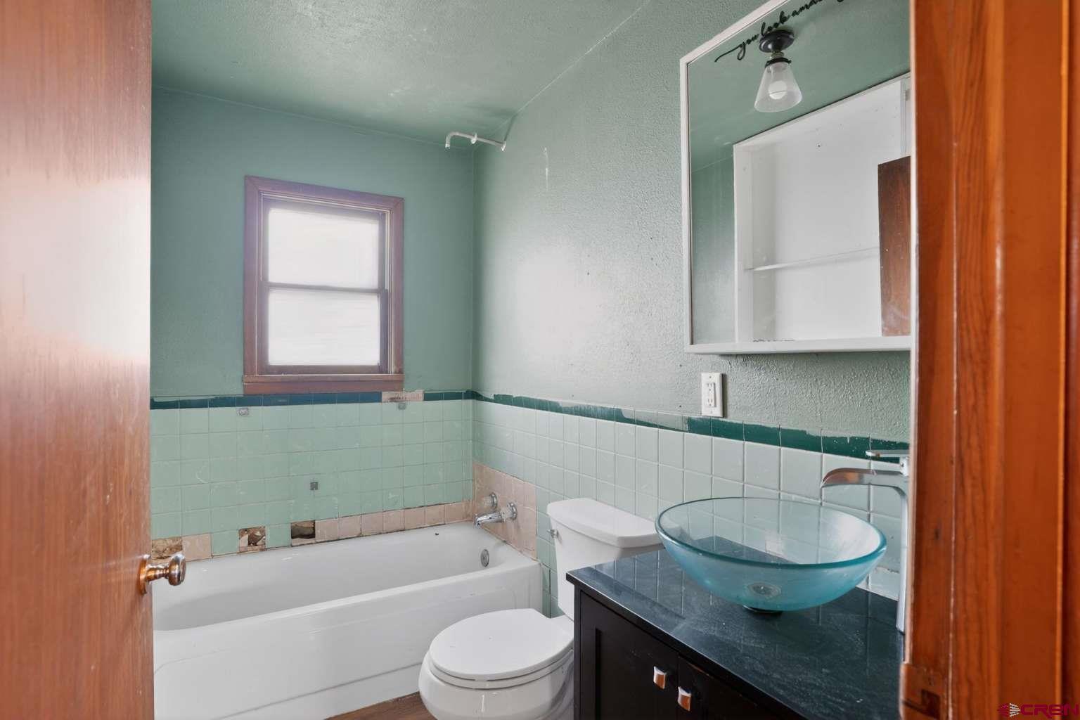 501 East 2nd Street Cortez, CO 81321 - Photo 24 of 30 a bathroom with a sink a toilet and bathtub