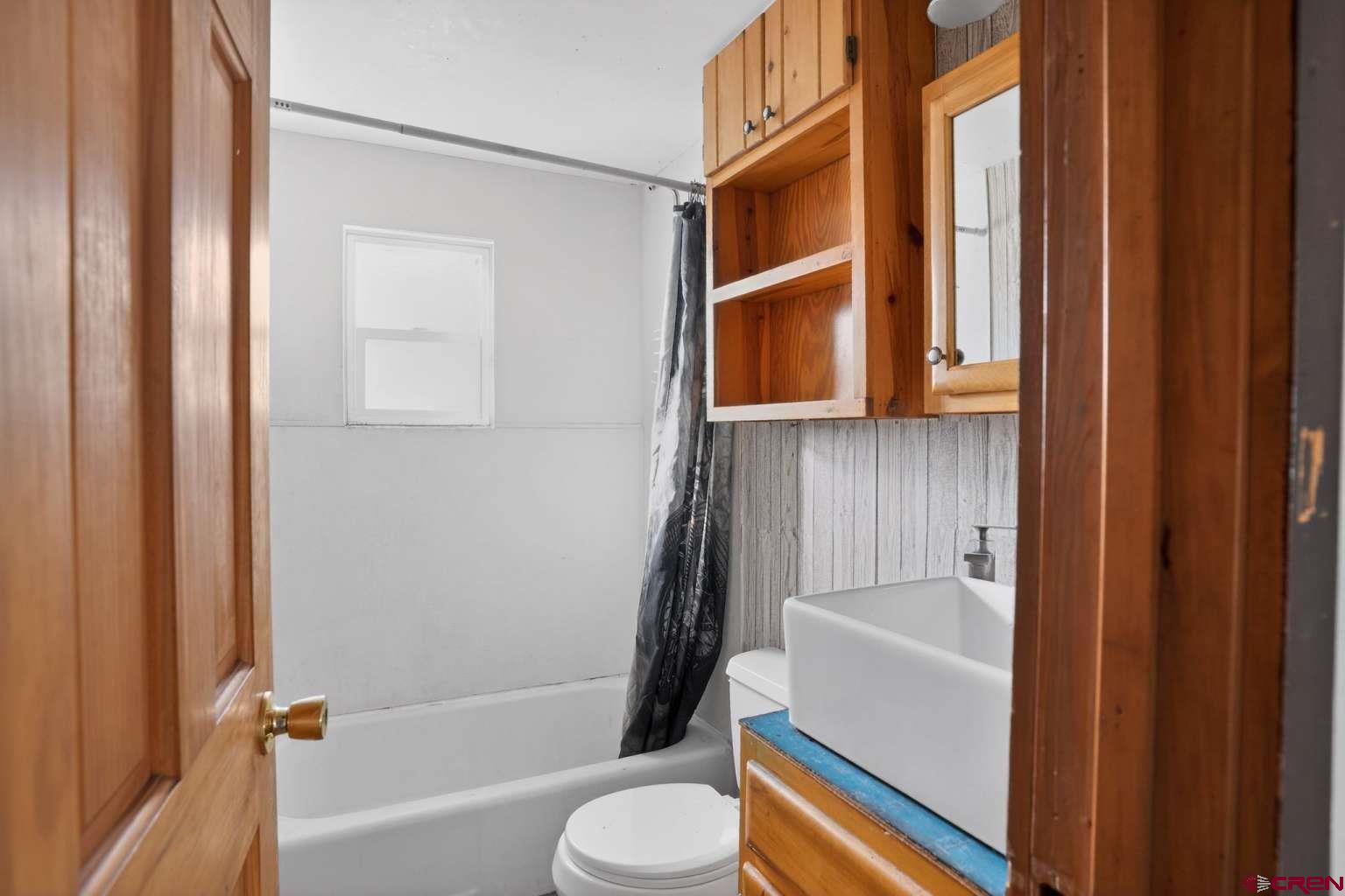 501 East 2nd Street Cortez, CO 81321 - Photo 25 of 30 a bathroom with a toilet and a bathtub