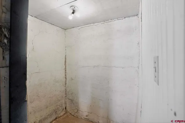 an empty room with window and closet