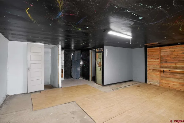 a view of a hallway with wooden floor and stairs