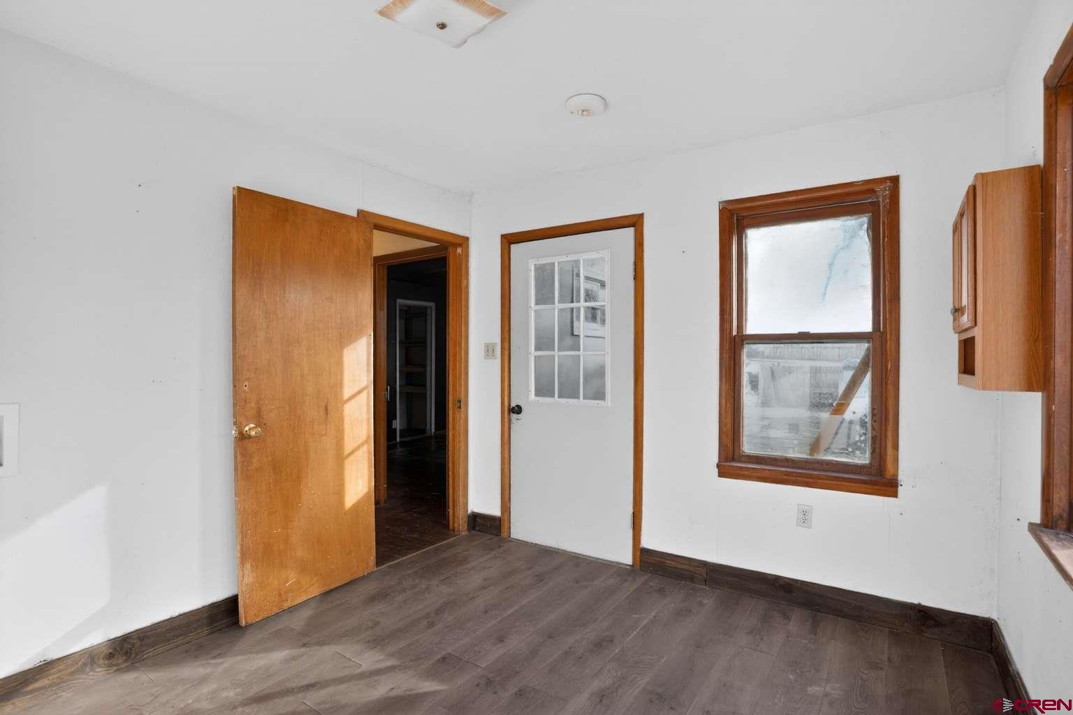 501 East 2nd Street Cortez, CO 81321 - Photo 9 of 30 a view of an empty room with wooden floor and window