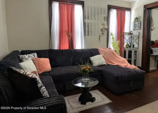 a living room with furniture and a mirror