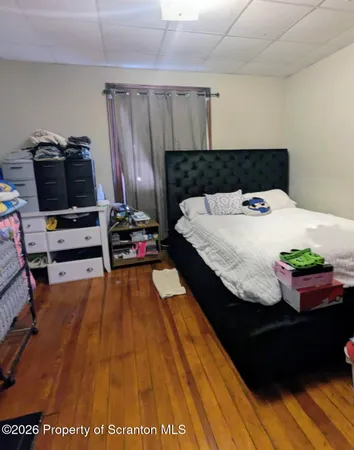 a bedroom with a bed and dresser