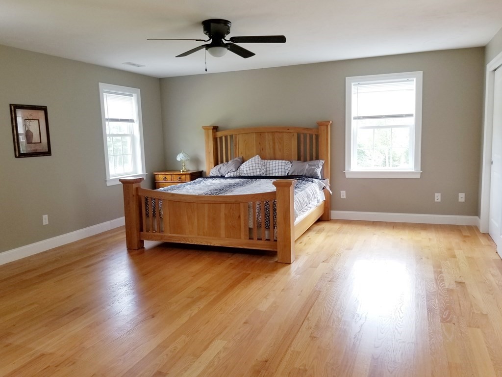 7 Dean Farm Road Sutton, MA 01590 - Photo 13 of 33 a spacious bedroom with a bed and wooden floor