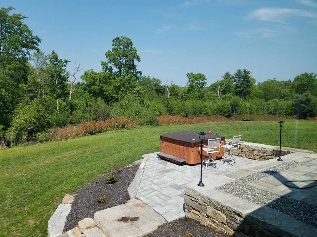 7 Dean Farm Road Sutton, MA 01590 - Photo 20 of 33 a backyard of a house with table and chairs