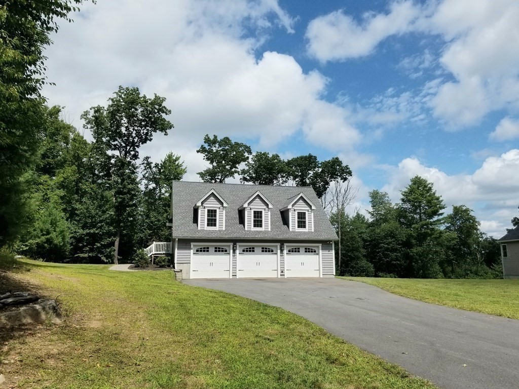 7 Dean Farm Road Sutton, MA 01590 - Photo 23 of 33 a view of a large house with a big yard and large trees