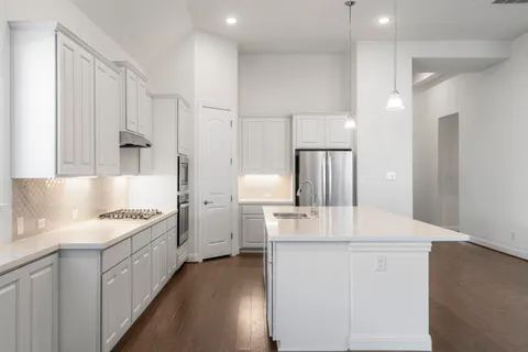 a kitchen with a sink stove and refrigerator
