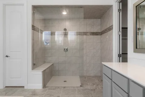 a bathroom with a shower and a sink