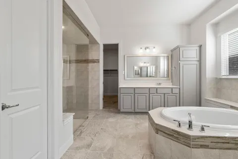 a bathroom with a bathtub and a shower