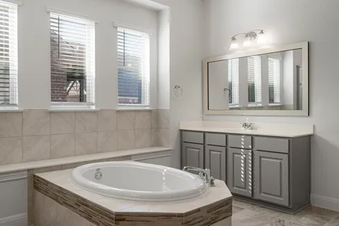 a bathroom with a bathtub and a sink