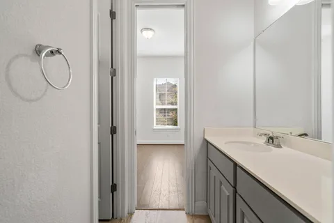 a bathroom with a shower sink and mirror