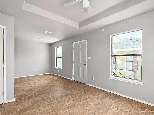 a kitchen with a refrigerator a stove a washer and a window