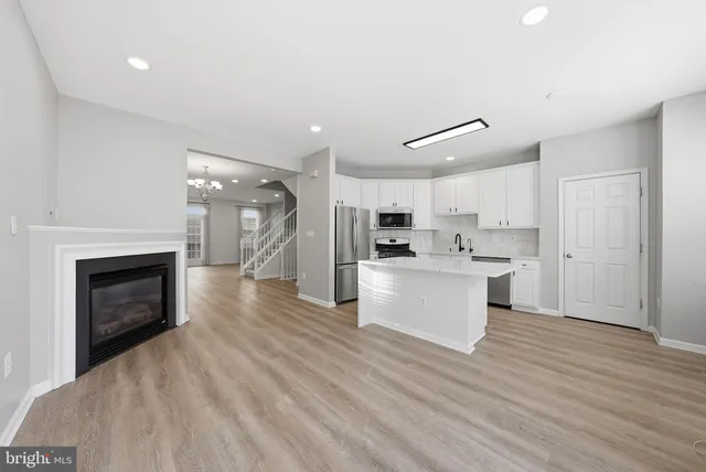 a view of kitchen with cabinets and wooden floor