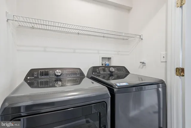 a close view of laundry room with a washer and dryer