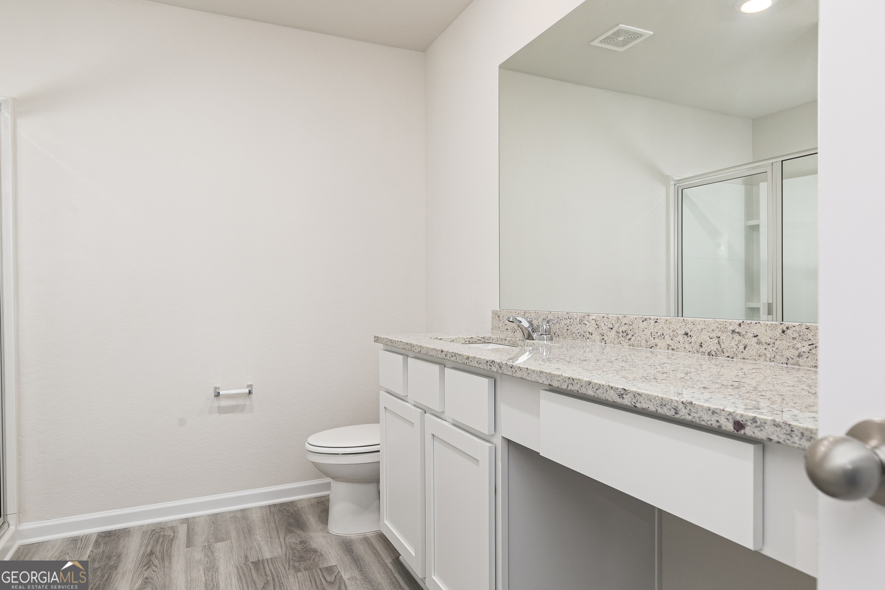 621 Slate Road Conyers, GA 30013 - Photo 14 of 21 a bathroom with a granite countertop sink a toilet and a mirror