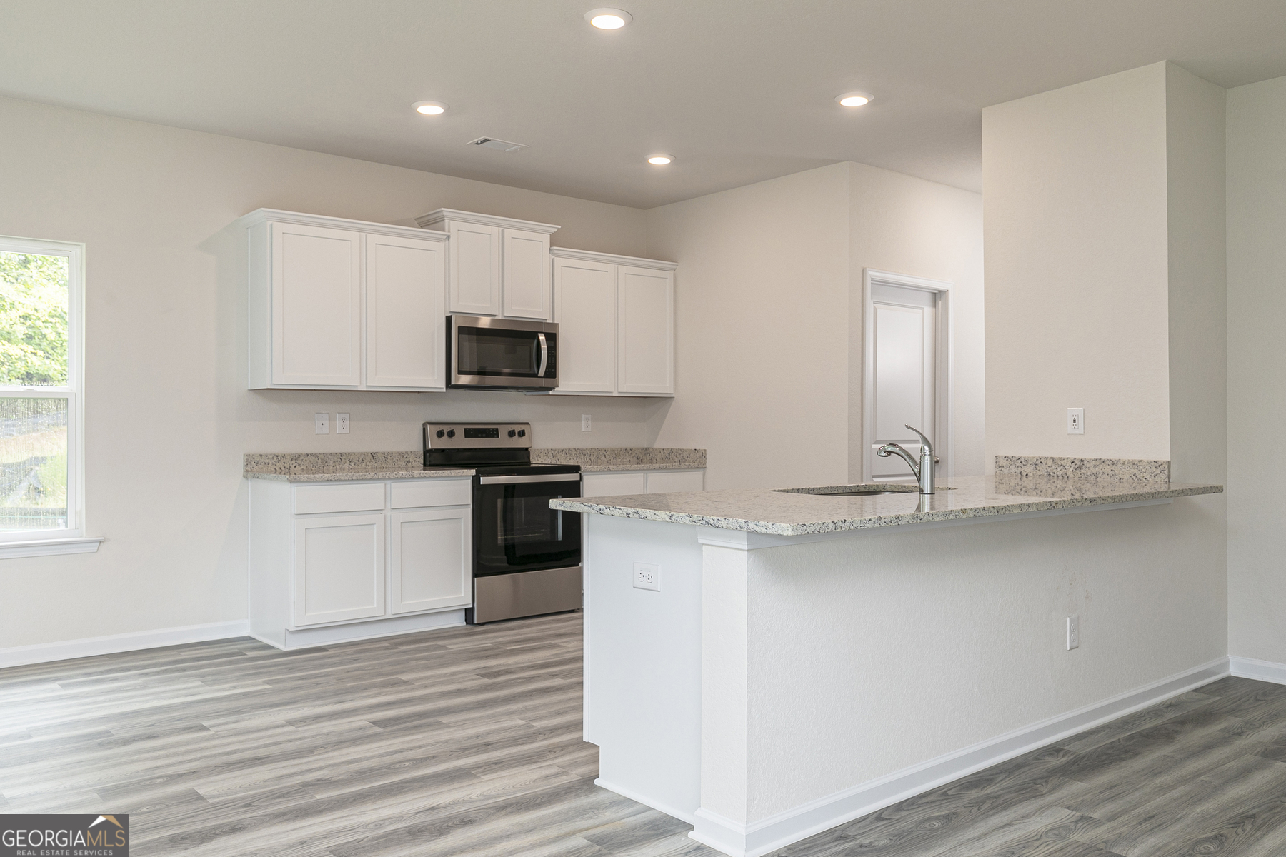 621 Slate Road Conyers, GA 30013 - Photo 6 of 21 a kitchen with granite countertop white cabinets and stainless steel appliances