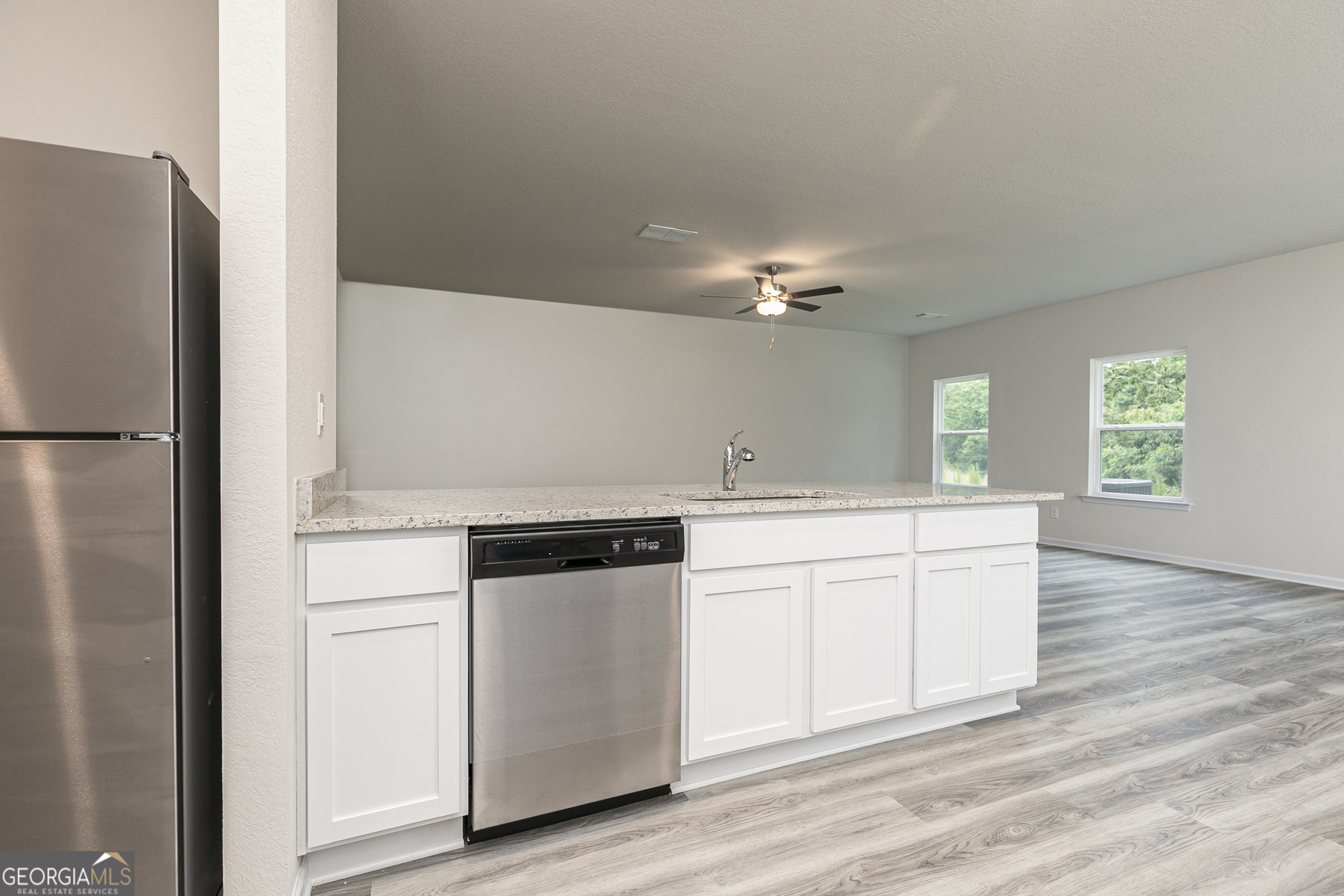 621 Slate Road Conyers, GA 30013 - Photo 9 of 21 a kitchen with granite countertop white cabinets and white appliances