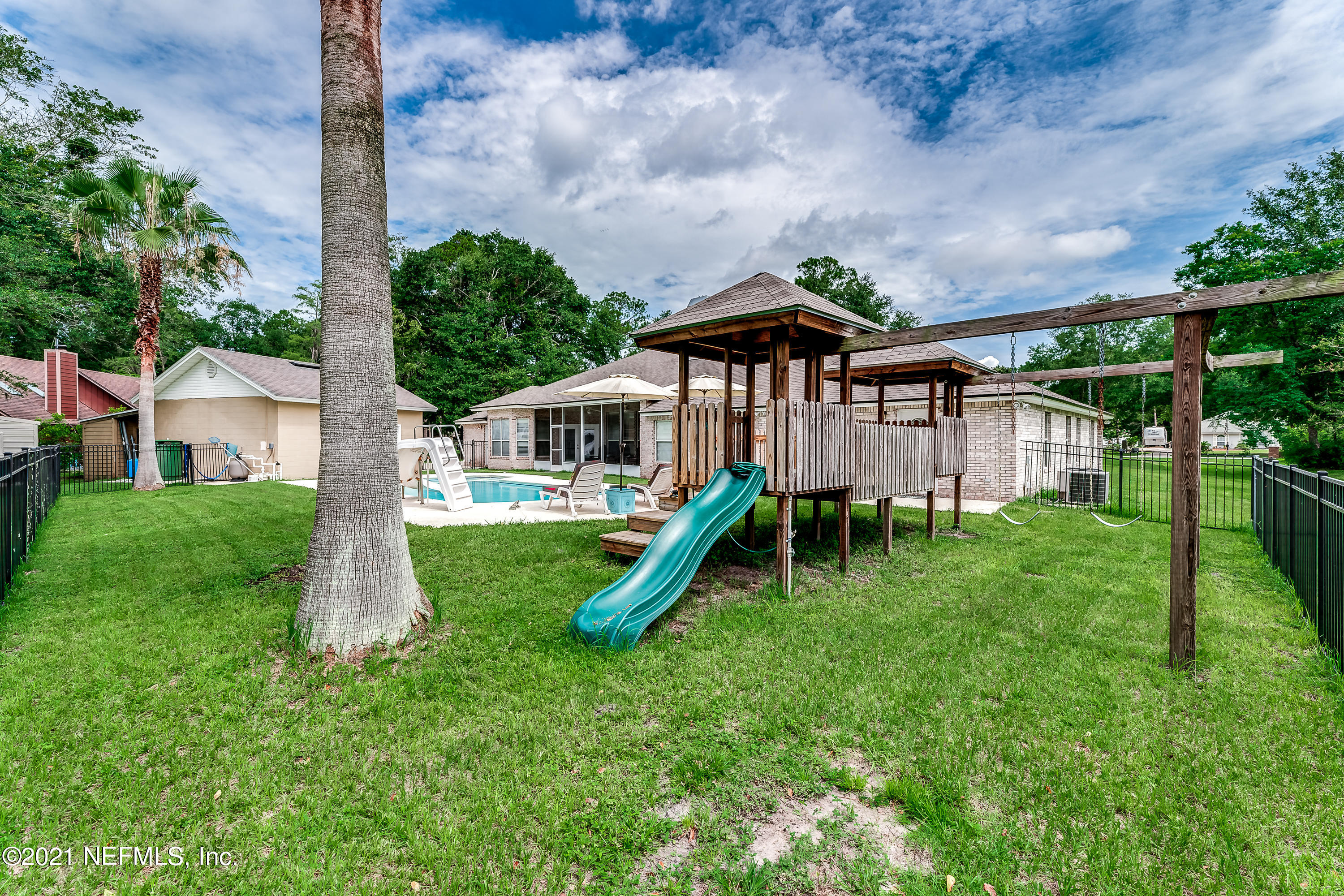 1123 Cactus Cut Road Middleburg, FL 32068 - Photo 16 of 66 a front view of a house with a yard table and chairs
