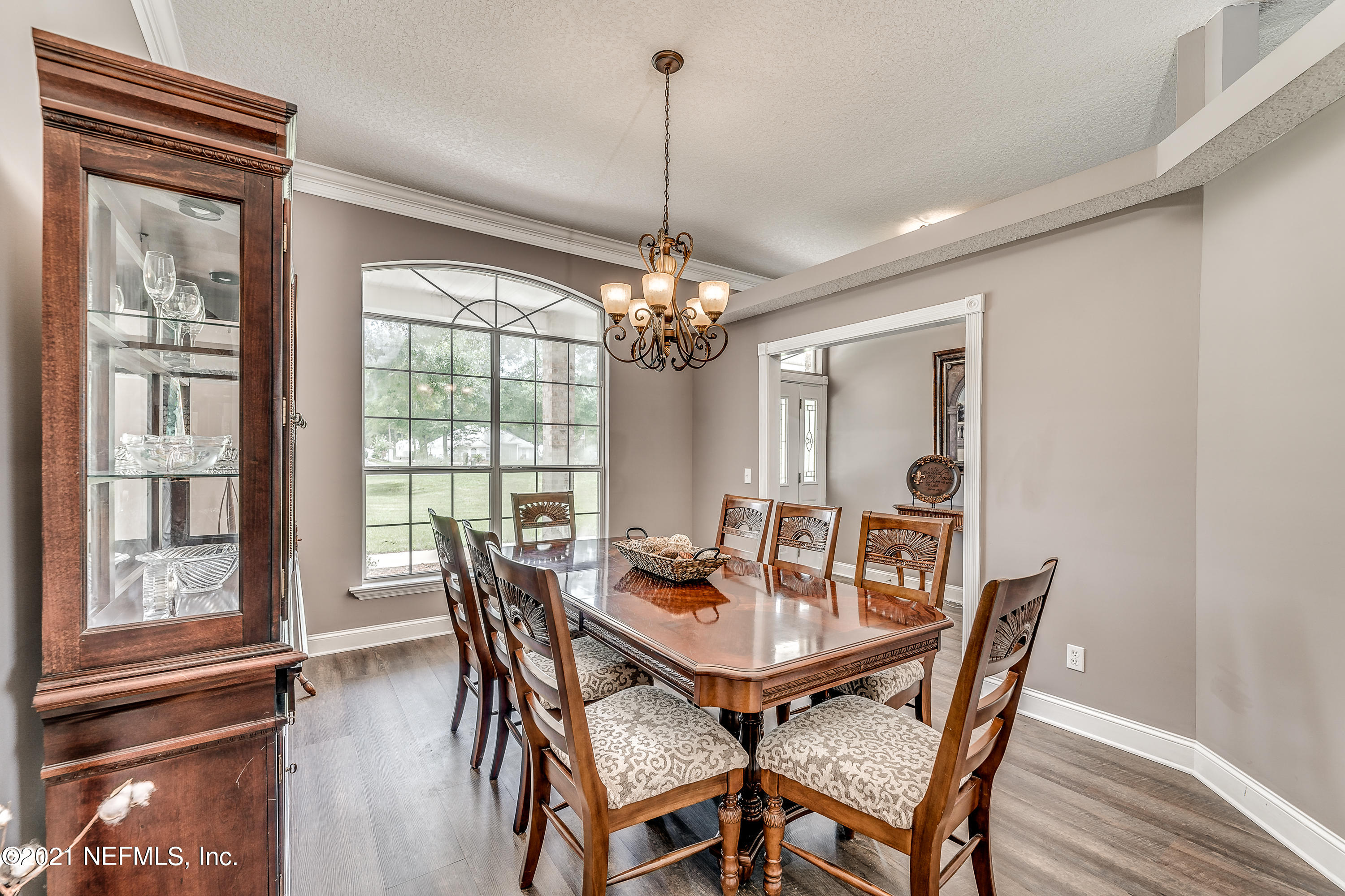 1123 Cactus Cut Road Middleburg, FL 32068 - Photo 24 of 66 a view of a dining room with furniture wooden floor and chandelier