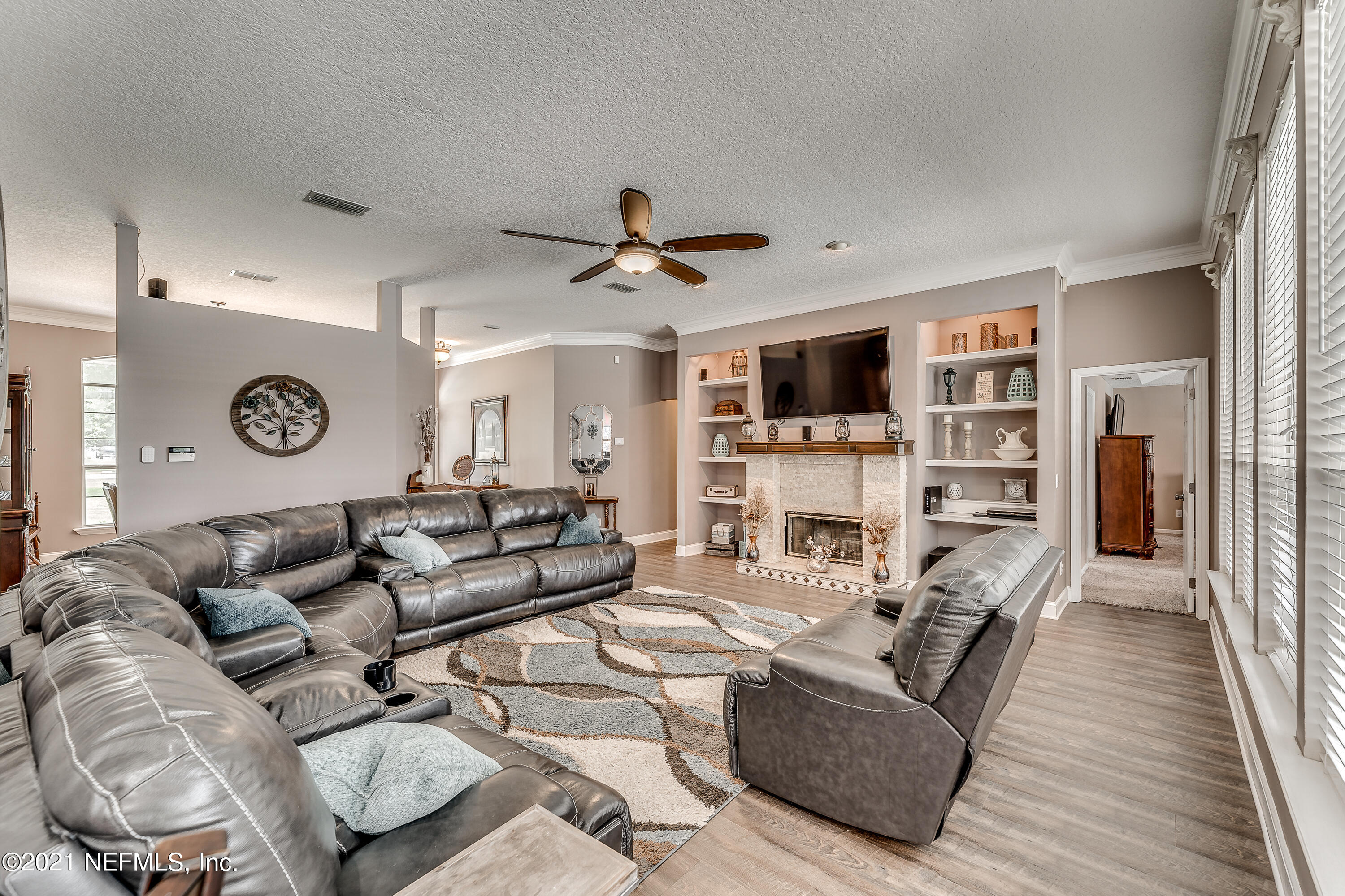 1123 Cactus Cut Road Middleburg, FL 32068 - Photo 27 of 66 a living room with furniture a fireplace and a flat screen tv