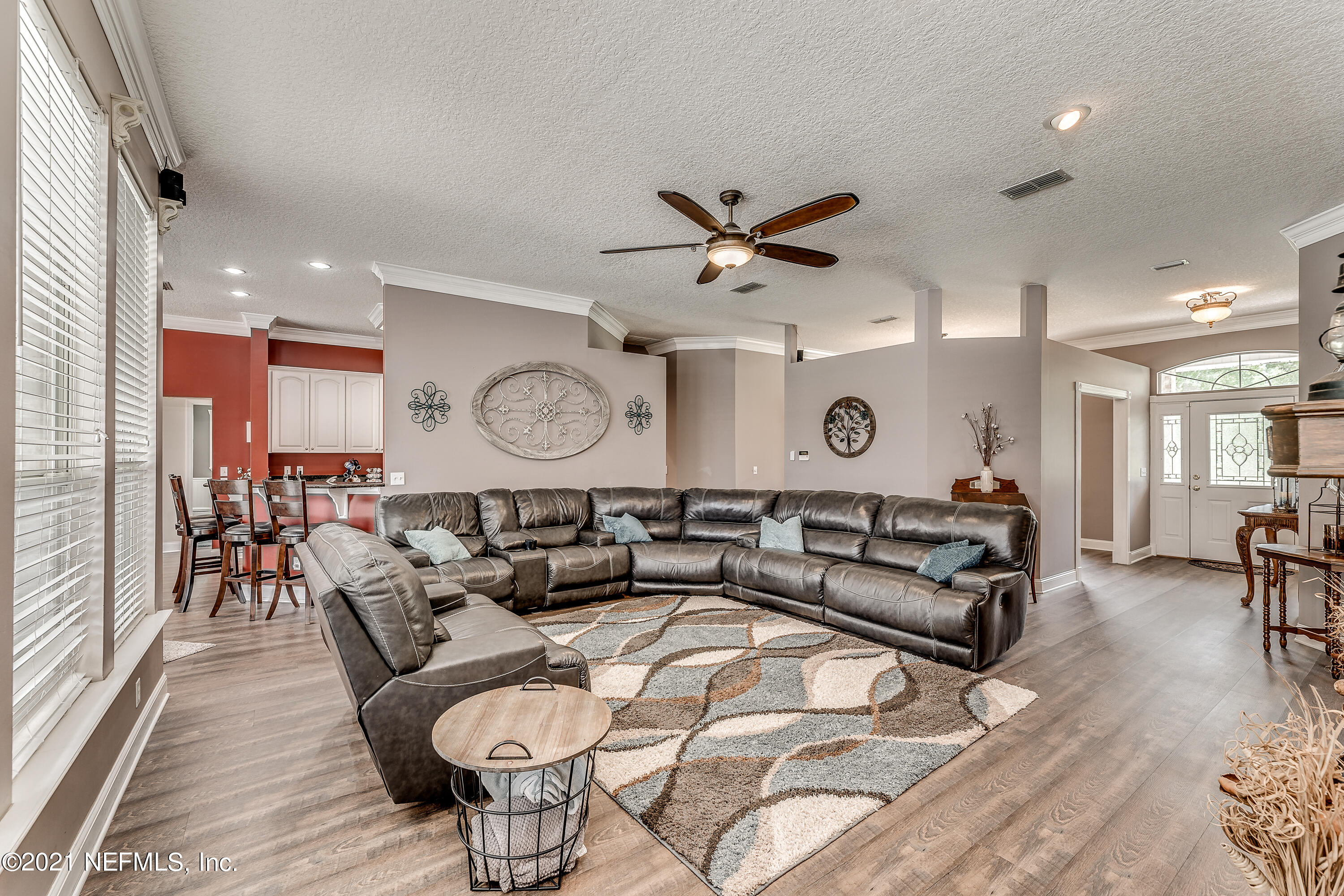 1123 Cactus Cut Road Middleburg, FL 32068 - Photo 28 of 66 a living room with furniture a clock on wall and a window