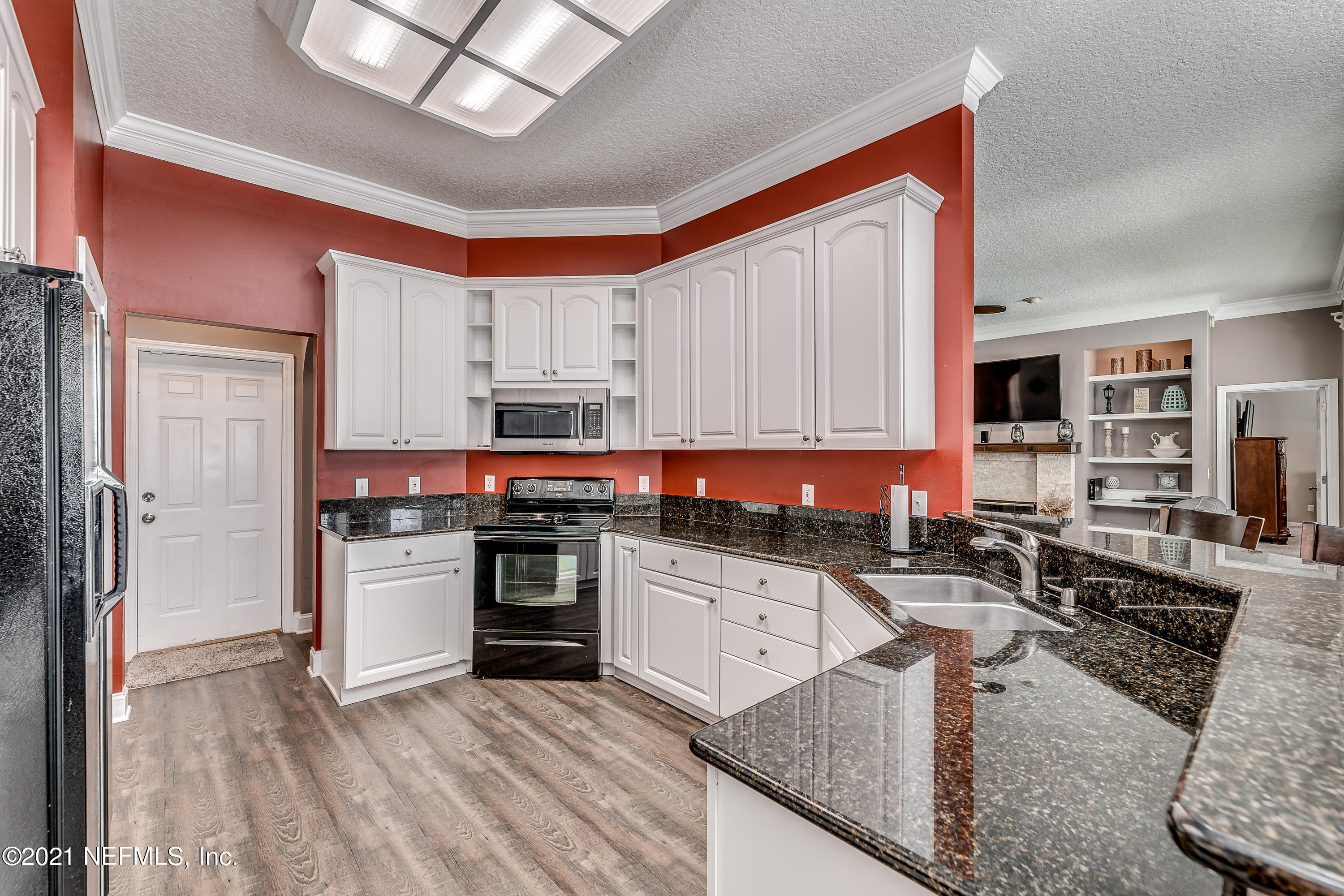 1123 Cactus Cut Road Middleburg, FL 32068 - Photo 33 of 66 a kitchen with stainless steel appliances granite countertop a stove sink and cabinets