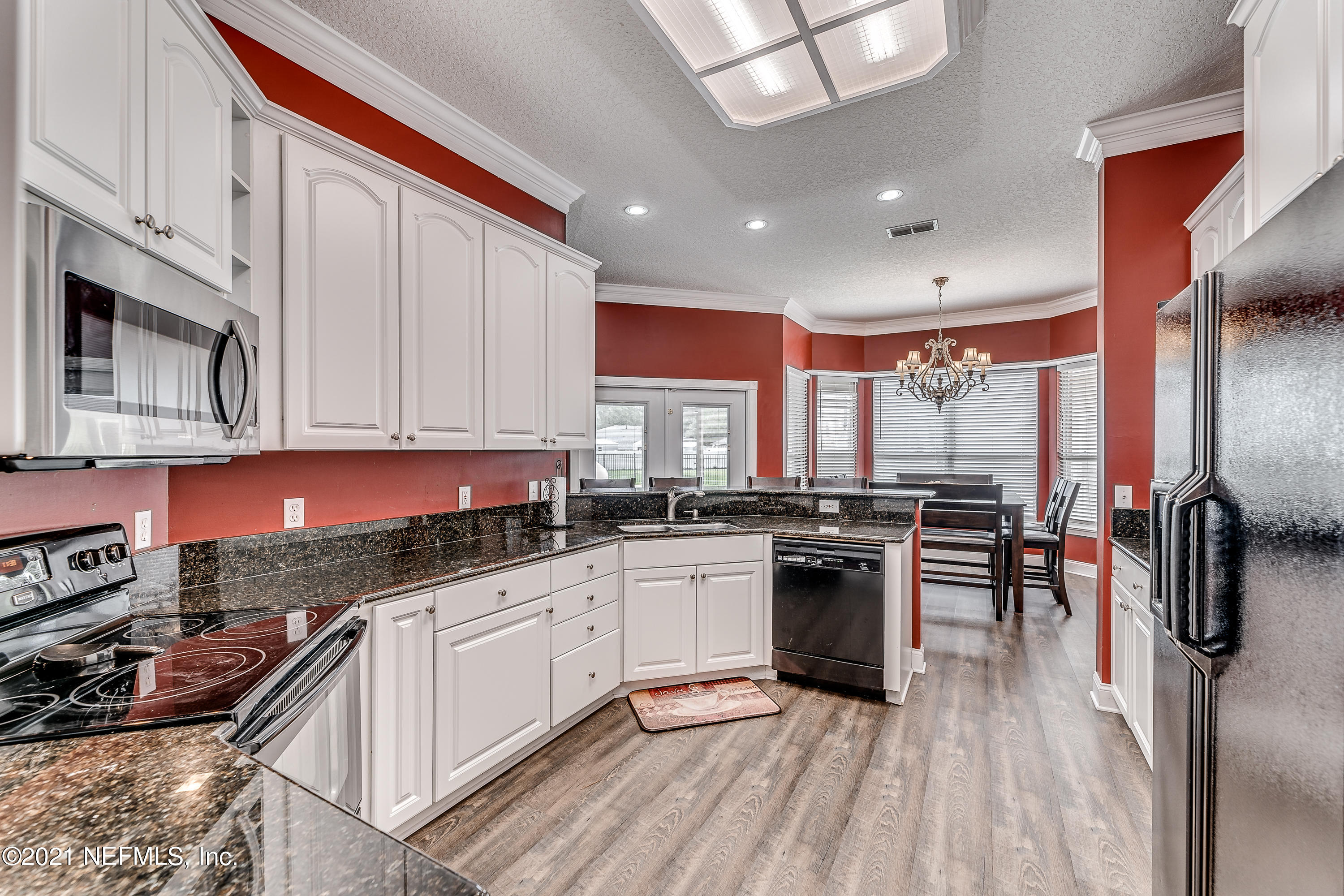 1123 Cactus Cut Road Middleburg, FL 32068 - Photo 34 of 66 a kitchen with stainless steel appliances granite countertop a stove top oven a sink and dishwasher
